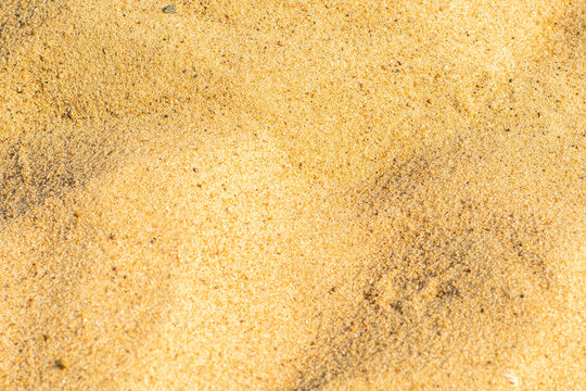 Close-up of sand on the beach. Toned photo with low depth of field. Small grains of sand on a clean beach.