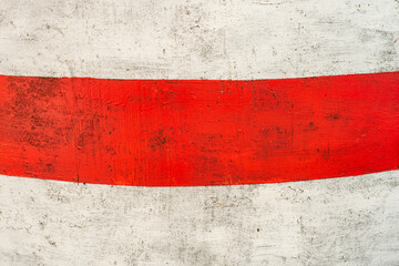 White metal wall with a wide red stripe. Old steel background with rust stains, scratches and scuffs