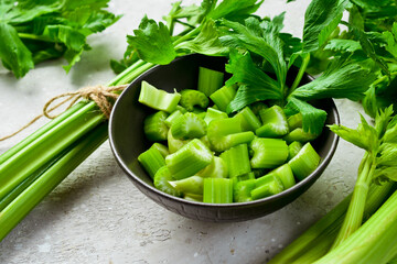 Celery stalk cut into pieces in a bowl. Vegan food. Free space for text.