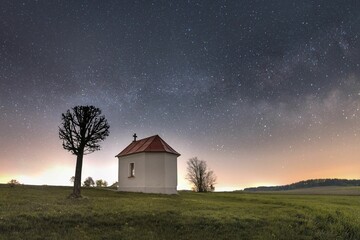 Exterior of a chapel under a starry sky