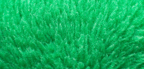 Green fluffy textile texture. Nappy hairy background closeup. banner