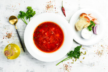 Borsch soup. Beetroot soup with sour cream, Ukrainian traditional cuisine. In a white plate. Top view.