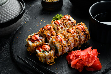 Delicious Sushi rolls with eel. Traditional Japanese food. On a black stone plate.