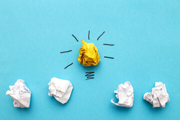 crumpled yelllow and white paper laightbulb as a concept creative idea and innovation