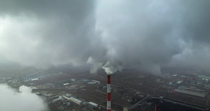 Aerial view of coal power plant high pipes with black smoke moving up polluting atmosphere
