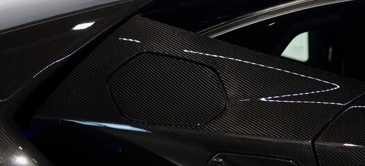 Sleek side view of carbon fiber sports car. Supercar background. Car wallpaper. Sleek sports car lambo. 
