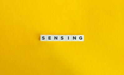 Sensing Word and Banner. Letter Tiles on Yellow Background. Minimal Aesthetics.