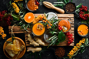 Autumn food concept: berries, honey, citrus fruits. Foods with a high content of vitamin C. On a dark background. top view