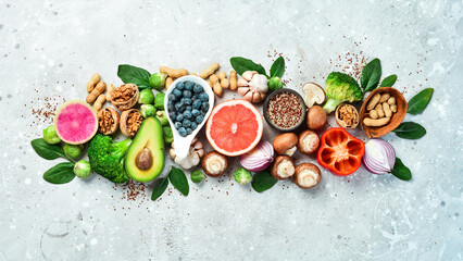 Healthy food background. Concept of Healthy Food, Fresh Vegetables, Nuts and Fruits. On a stone...