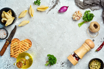 Cooking. Background with vegetables, spices, herbs and kitchen utensils. On a stone background. Top view.