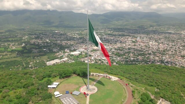 Spin around Mexican flag over the city of Iguala in the state of Guerrero