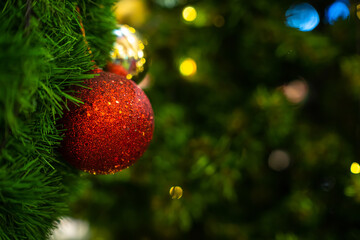 Merry x-mas,Close up of Colorful balls ,gifts box and Christmas greeting picture parcel decoration on Green Christmas tree background Decoration During Christmas and New Year.