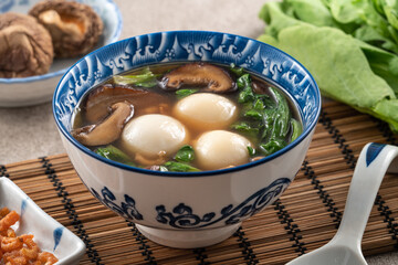 Eating big tangyuan yuanxiao with savory soup in Taiwan.