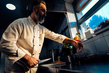 Chef cooking in a commercial kitchen.