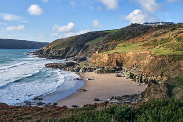 Beautiful sandy bay and cliffs by the Devon coast path - obrazy, fototapety, plakaty