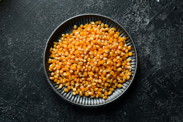 Popcorn and corn for popcorn on kitchen table. Top view.