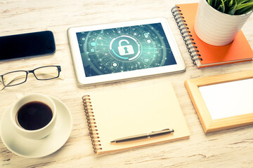 Web security and technology concept with tablet pc on wooden table