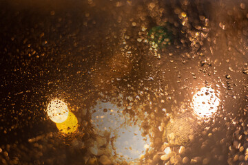 Blurred background with raindrops and lights.
