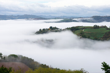 Morning mist and clouds over the Montefeltro hills near Belvedere Fogliense between Pesaro and...