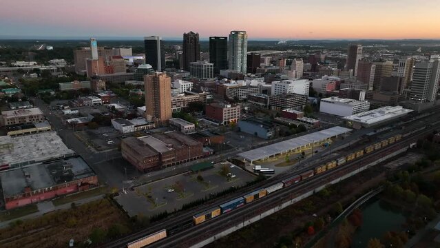 Birmingham Alabama skyline at dawn. Downtown skyscrapers and train at dawn. Aerial view.