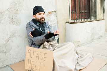 Cold homeless man shivering and begging for money