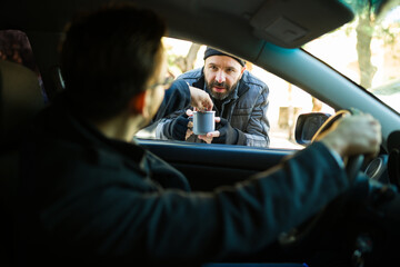 Miserable poor homeless man begging on the street