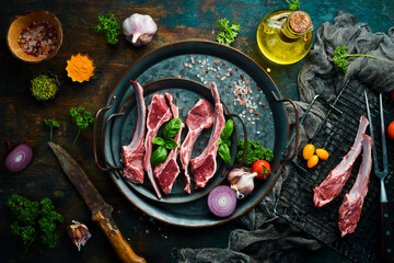 Meat. Raw lamb ribs on a metal tray, preparation for baking. Rustic style. Photo for the catalog. © Yaruniv-Studio