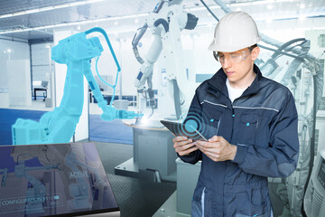 Engineer uses a digital tablet to control robots in a smart factory. Smart industry 4.0 concept