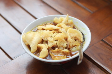 a close up of a ready-to-serve bowl of chicken porridge
