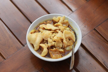 a close up of a ready-to-serve bowl of chicken porridge