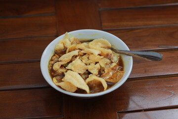a close up of a ready-to-serve bowl of chicken porridge
