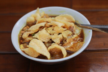 a close up of a ready-to-serve bowl of chicken porridge