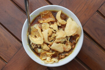 a close up of a ready-to-serve bowl of chicken porridge