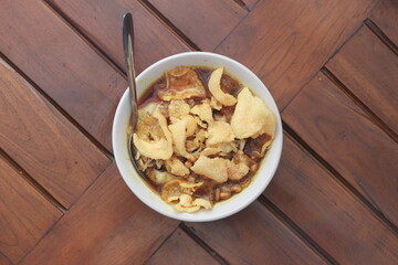 a close up of a ready-to-serve bowl of chicken porridge