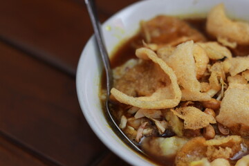 a close up of a ready-to-serve bowl of chicken porridge