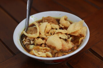 a close up of a ready-to-serve bowl of chicken porridge