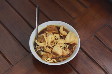 a close up of a ready-to-serve bowl of chicken porridge
