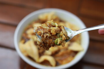 a close up of a ready-to-serve bowl of chicken porridge
