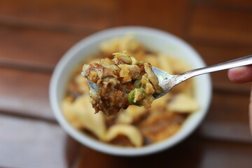 a close up of a ready-to-serve bowl of chicken porridge