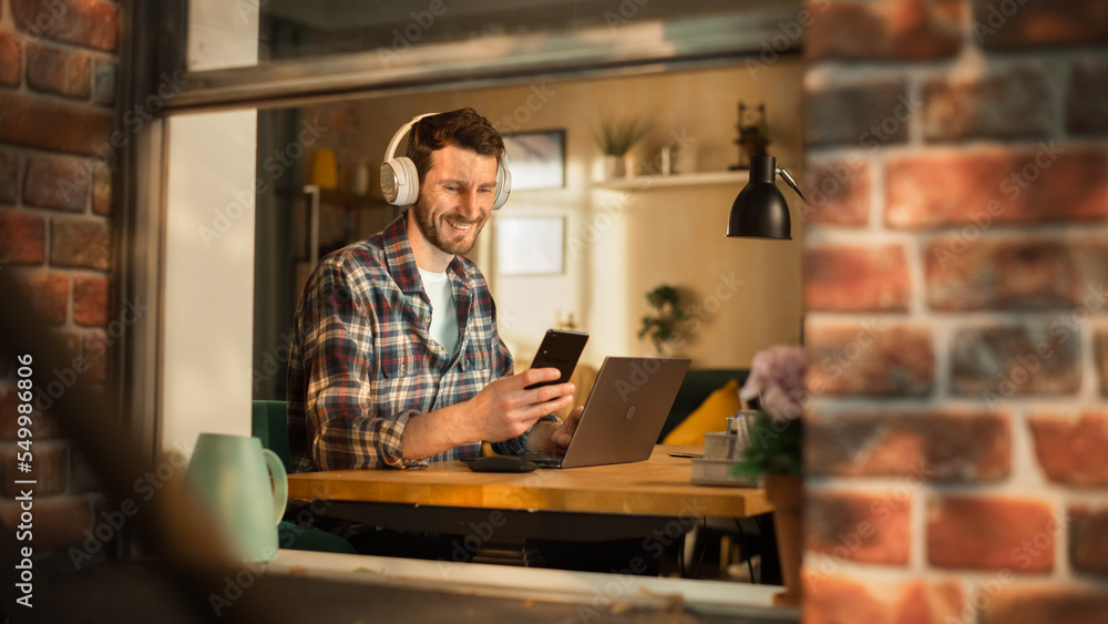 Aufkleber handsome caucasian man working on laptop computer while sitting behind his desk at home office. free