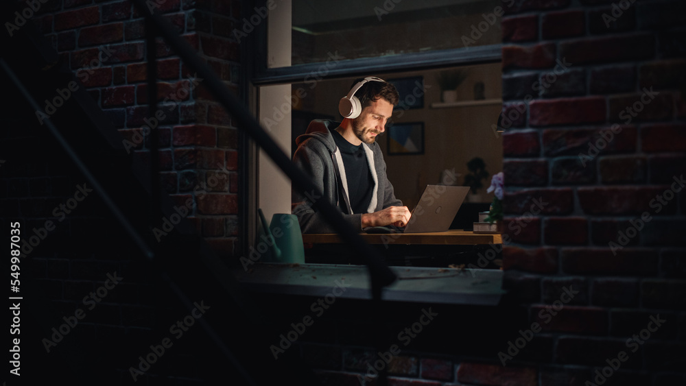 Poster software developer programming on a laptop late night. male specialist browsing internet, listening 