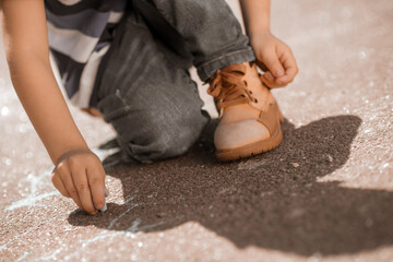 Boy drawing something on the ground