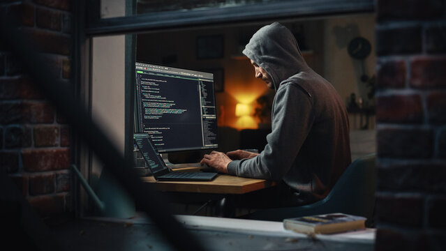 Single-Minded Professional Programmer Obsessively Writing a Code on His Desktop Computer, Late at Night. IT Specialist Ethical Hacker Working on Computer and Finding Software Vulnerabilities.