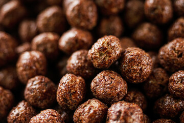 sweet crunchy chocolate children's breakfast chocolate balls on a white background