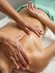 osteopathic massage,back massage, massage therapist doing back massage close-up,wellness massage