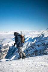 Male snowboarder on top of mountain in Austria with equipment. High quality image of snowboarding man on snowy mountain.