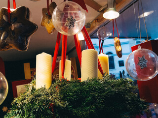 Selective focus of christmas advent wreath with candles on counter with different decor
