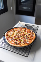 Vegetable and ham pizza freshly made in the home oven. Healthy food concept. Cook at home.