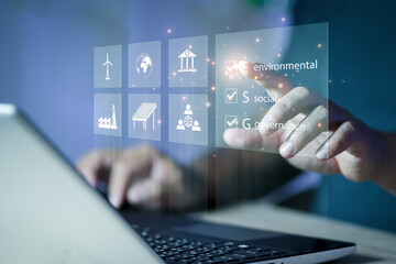 ESG. environment social governance investment business concept. Businessmen use a computer to analyze ESG, surrounded by ESG icons close to the computer screen in business investment strategy concept.