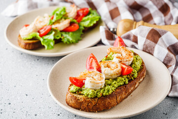 delicious Italian bruschetta with shrimps on a gray stone background